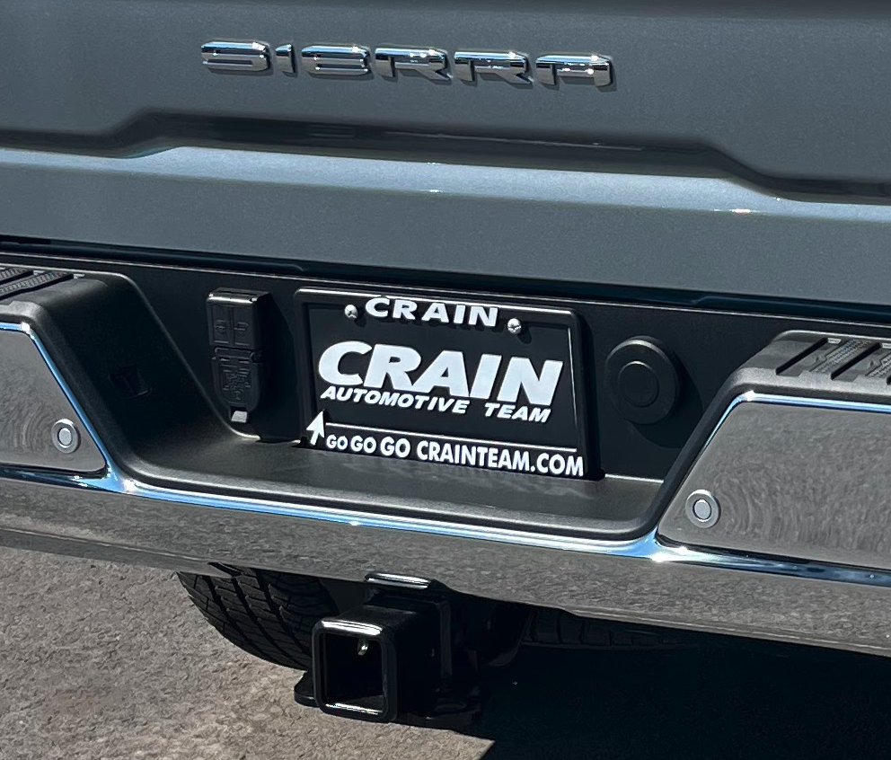 Close-up of GMC Sierra rear with Crain Automotive Team license plate at Crain Buick GMC in Conway